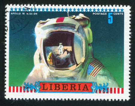 LIBERIA - CIRCA 1972: stamp printed by Liberia, shows Moon scene reflected in astronauts helmet, circa 1972のeditorial素材
