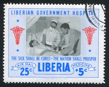 LIBERIA - CIRCA 1954: stamp printed by Liberia, shows Medical examination, circa 1954のeditorial素材