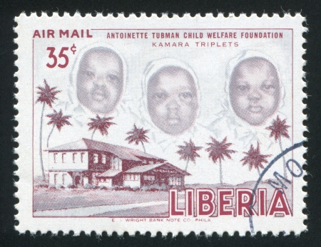 LIBERIA - CIRCA 1957: stamp printed by Liberia, shows The Kamara triplet, circa 1957のeditorial素材