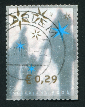 NETHERLANDS - CIRCA 2004: Christmas stamp. Shades of people, circa 2004.のeditorial素材