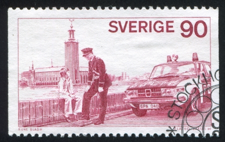 SWEDEN - CIRCA 1975: stamp printed by Sweden, shows Officer talking to boy on bridge, circa 1975のeditorial素材