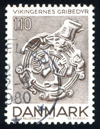 DENMARK - CIRCA 1979: stamp printed by Denmark, shows Viking Art Gripping beast pendant, circa 1979のeditorial素材