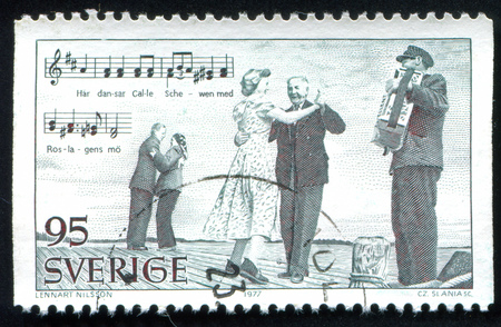 SWEDEN - CIRCA 1977: stamp printed by Sweden, shows Dancers and accordionist, circa 1977のeditorial素材