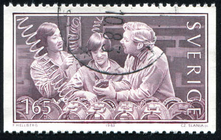 SWEDEN - CIRCA 1982: stamp printed by Sweden, shows Vietnamese Workers in Sweden, circa 1982のeditorial素材
