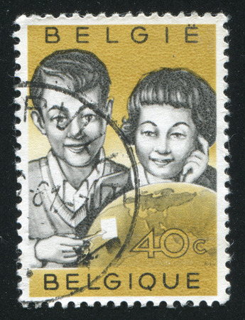 RUSSIA KALININGRAD, 20 OCTOBER 2015: stamp printed by Belgium, shows Children Examining Stamp and Globe, circa 1960のeditorial素材