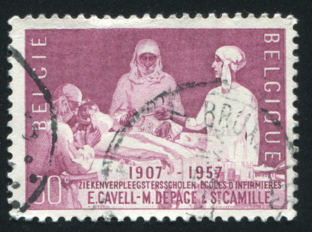 RUSSIA KALININGRAD, 20 OCTOBER 2015: stamp printed by Belgium, shows Queen Elisabeth Assisting at Operation, circa 1957のeditorial素材