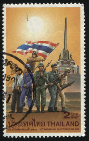 RUSSIA KALININGRAD, 31 MAY 2016: stamp printed by Thailand, shows illustration of soldiers, holding national flag, dedicated to 50th anniversary of veterans day, circa 1998のeditorial素材