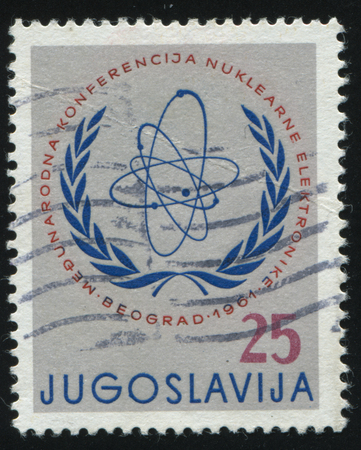 RUSSIA KALININGRAD, 12 NOVEMBER 2016: stamp printed by Yugoslavia, shows International Atomic Energy Comission Emblem, circa 1961のeditorial素材
