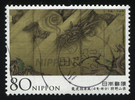 RUSSIA KALININGRAD, 22 APRIL 2016: stamp printed by Japan, shows crouching dragon, circa 2012のeditorial素材