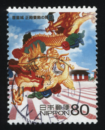 RUSSIA KALININGRAD, 22 APRIL 2016: stamp printed by Japan, shows a dragon flying above the town, circa 2010のeditorial素材