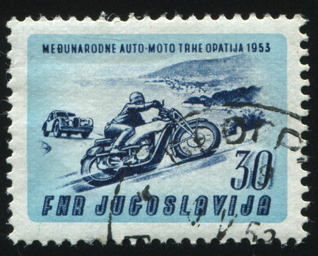 RUSSIA KALININGRAD, 12 NOVEMBER 2016: stamp printed by Yugoslavia, shows motocycle and auto in Opatija, circa 1953のeditorial素材