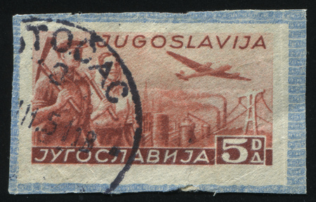 RUSSIA KALININGRAD, 12 NOVEMBER 2016: stamp printed by Yugoslavia, shows plane and two walking men, circa 1971のeditorial素材