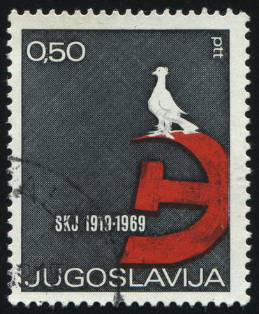 RUSSIA KALININGRAD, 12 NOVEMBER 2016: stamp printed by Yugoslavia, shows dove, hammer and sickle, circa 1969のeditorial素材