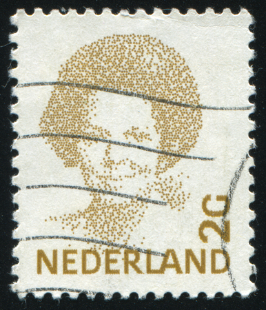 RUSSIA KALININGRAD, 27 JUNE 2017: stamp printed by Netherlands shows emblem, figure, number and symbol, circa 1981のeditorial素材