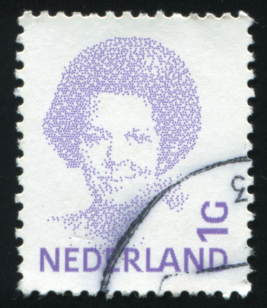 RUSSIA KALININGRAD, 27 JUNE 2017: stamp printed by Netherlands shows emblem, figure, number and symbol, circa 1981のeditorial素材