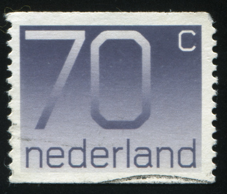 RUSSIA KALININGRAD, 21 JUNE 2017: stamp printed by Netherlands shows emblem, figure, number and symbol, circa 1976のeditorial素材