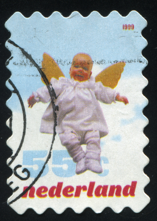 RUSSIA KALININGRAD, 21 JUNE 2017: stamp printed by Netherlands shows baby angel, circa 1999のeditorial素材