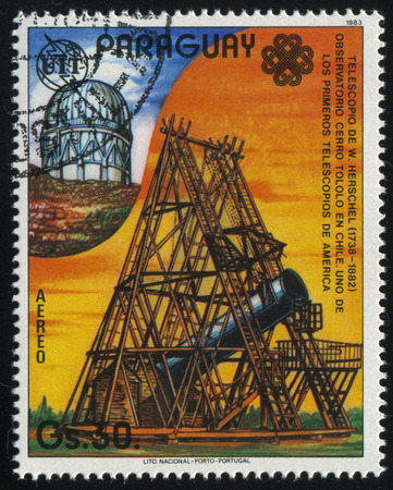 RUSSIA KALININGRAD, 19 APRIL 2017: stamp printed by Paraguay, shows Herschel's telescope, Cerro Tololo Observatory  in Chile, circa 1983のeditorial素材