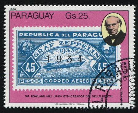 RUSSIA KALININGRAD, 22 APRIL 2017: stamp printed by Paraguay, shows Sir Rowland Hill and a stamp reproducing airship Graf Zeppelin, circa 1980のeditorial素材
