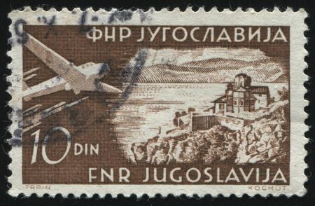 RUSSIA KALININGRAD, 12 NOVEMBER 2016: stamp printed by Yugoslavia, shows airplane and Ohrid, circa 1951のeditorial素材