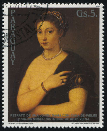 RUSSIA KALININGRAD, 19 APRIL 2017: stamp printed by Paraguay, shows Portrait of a Young Woman with a Fur Cape by Titian, circa 1989のeditorial素材