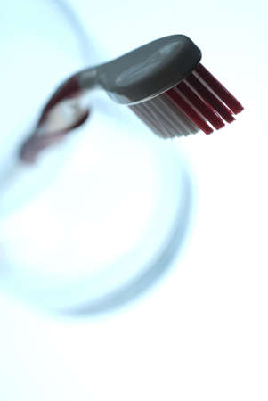 Close-up of a toothbrush with sharp focus on head, creating suggestive backlight composition.