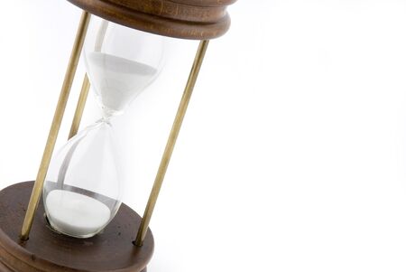 Old style hourglass with white sand on a white background