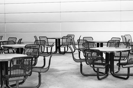 Empty chairs and tables at a restaurantの写真素材