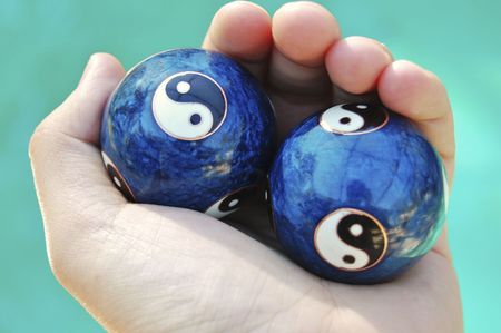 Ying yang balls in handの写真素材
