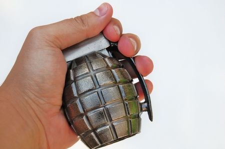 Hand holding a grenade on white backgroundの写真素材