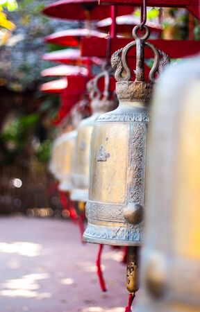 Row of metal bells in Thai temple.の写真素材
