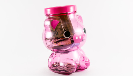 Plastic pink piggy bank on a white background.の写真素材