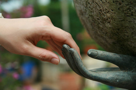 female human hand and stone hand statueの写真素材