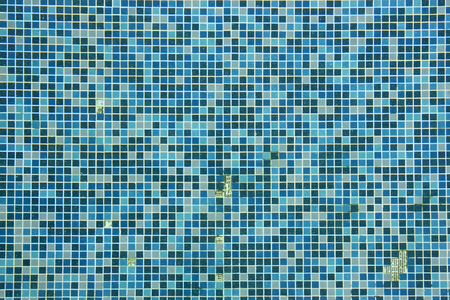Broken blue ceramic tiled texture background of swimming pool.の写真素材