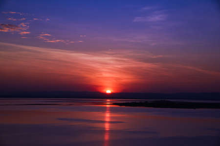 Sunset behind the mountain at lakeの写真素材