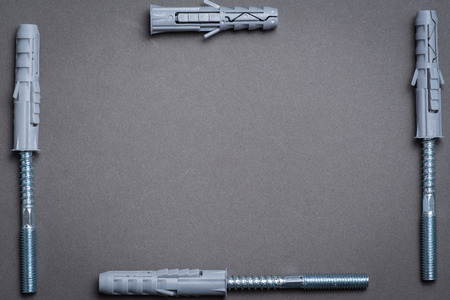 Plastic dowels and screws on grey surface