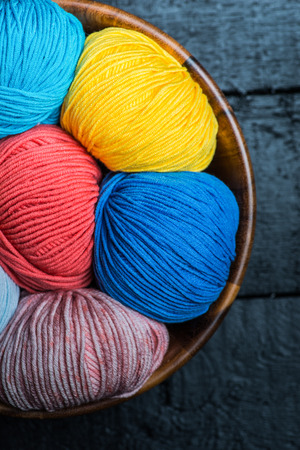 Colorful knitting yarn balls in basketの写真素材