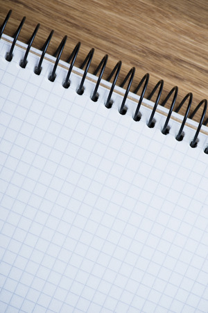 Blank spiral notebook on an oak wood tableの写真素材