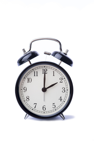 Black vintage style alarm clock over the white background, islolated