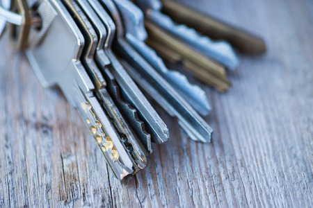 A bunch of vintage keys on the wooden table