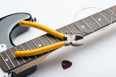 Guitar frets with string, mediator and yellow nippersの写真素材