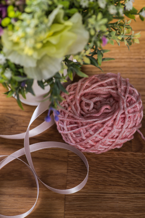 Ball of knitting yarn with flowersの写真素材