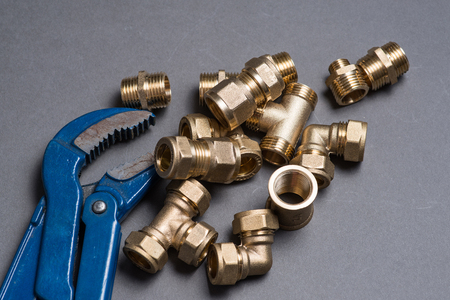 Adjustable wrench and connection fittings on greyの写真素材