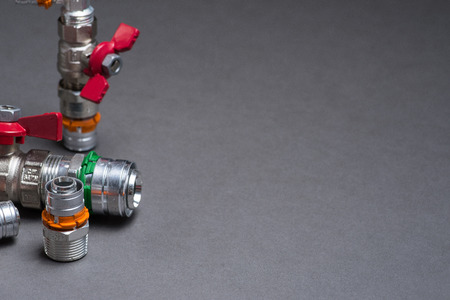 Water valves with fittings on grey background