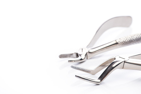 Two extraction forceps on white surfaceの写真素材