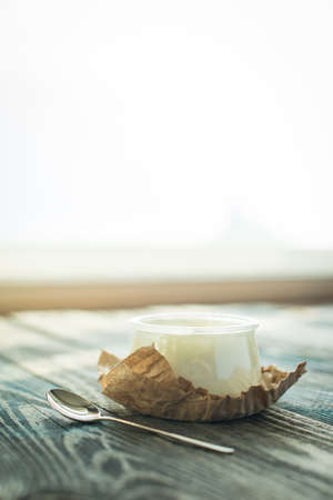 Jar with fresh yogurt on a rustic wooden tableの写真素材