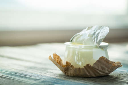 Jar with fresh yogurt on a rustic wooden tableの写真素材