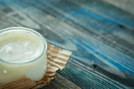 Jar with fresh yogurt on a rustic wooden tableの写真素材