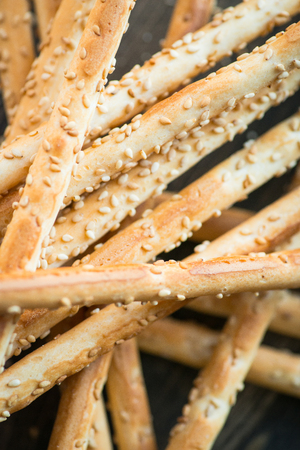 Bunch of homemade grissini breadsticks on wooden table