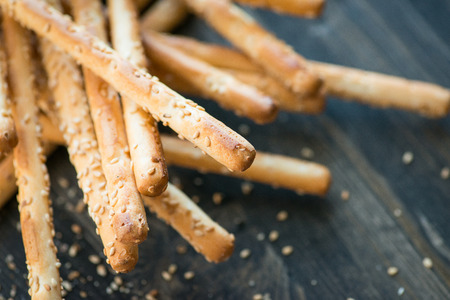 Bunch of homemade grissini breadsticks on wooden table